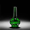 An octagonal facetted green glass bottle vase. Qianlong wheel-cut four-character mark and of the period. photo Bonhams