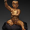 Gilt-lacquered wood figure of a seated boy. china, song-yuan dynasty, 13th-14th century