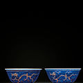 A very rare pair of blue-ground underglaze-red decorated 'dragon' bowls, kangxi six-character marks and of the period