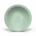 A celadon-glazed incised floral bowl, qianlong six-character seal mark in underglaze and of the period (1736-1795)