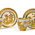 A pair of meissen augsburg-decorated coffee cups and saucers, circa 1725-35