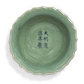 A small incised celadon-glazed 'floral' dish, xuande mark and period (1426-1435)