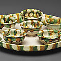 A sancai-glazed pottery circular tray and six cups, Tang dynasty (AD 618-907)