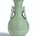 A rare moulded 'Longquan' celadon ring-handled vase, Yuan dynasty