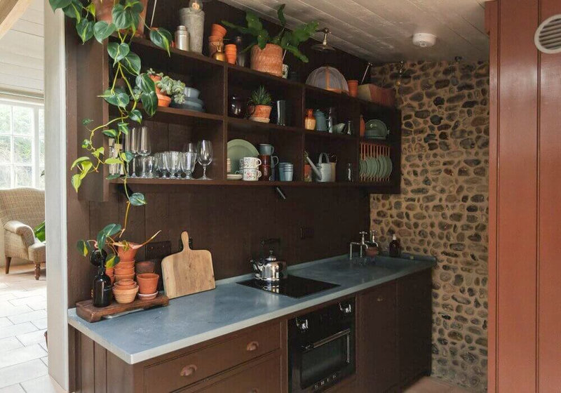 brown-kitchen-cabinets-stone-wall-open-cabinets-nordroom