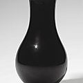 A rare small black-glazed pear-shaped vase, kangxi six-character mark in underglaze blue and of the period (1662-1722)