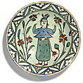 An iznik polychrome pottery dish with standing figure, turkey, 17th centur