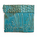 A moulded turquoise-blue glazed pottery border tile, kashan, central iran, 13th century