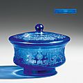 A transparent blue glass footed bowl with matching lid