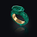 A carved emerald and gold ring