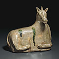 A very rare grey-green-glazed porcelaneous figure of a recumbent mythical creature, China, probably Tang dynasty