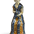 A rare and important blue and amber-glazed pottery figure of a court lady, Tang dynasty